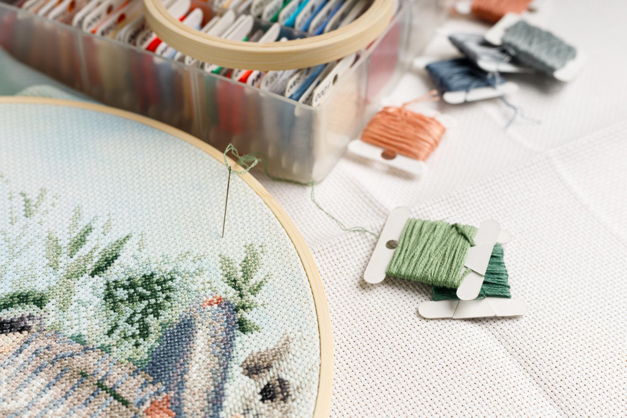 Workshop table with threads and embroidered sample
